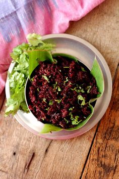 a white bowl filled with beetroot fry on top of a wooden table