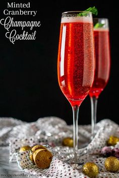 two wine glasses filled with champagne and garnish