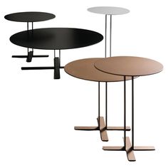 three tables with different shapes and sizes on each table, one is black, the other has white