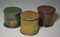 three ceramic containers sitting next to each other