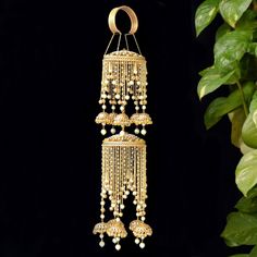 These double layer Kaleeras with contemporary styling of traditional elements like kundans, pearls and ghungroos will look absolutely stunning with any kind of outfit/color. If you want something exquisite and contemporary but also want to keep the traditional feel alive, choose this pair of Double Layer Golden Jhumki Kaliree with geometric twist. * 1 Pair * Length of the kaleera without the extension bangle/chain is 14 inches. * Width: 3.5 inches * Comes with the adjustable bangle suitable for any wrist size. * Weight of 1 piece 140 grams Approx. Keep your jewelry away from water, soap, perfumes and other hard chemicals. If you want to clean it then wipe it gently with the not too wet cloth. SHIPPING: > Import duties and taxes (if any) ARE NOT INCLUDED. Please check the same for your coun Festive Gota Work Chandbalis For Reception, Gold Chandbalis With Tilla For Reception, Traditional Gold Chandbalis For Reception, Diwali Reception Chandbalis With Gota Work, Bollywood Style Jhumkas For Reception And Festivals, Gold Chandbalis With Latkans For Reception, Gold Jhumkas With Gota Work For Celebration, Traditional Jhumkas For Receptions And Festivals, Traditional Chandbalis For Receptions And Festivals