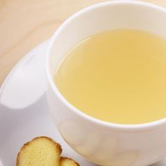 a cup of tea and two pieces of bread on a plate