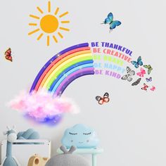 a child's bedroom with a rainbow wall decal and butterflies on the walls