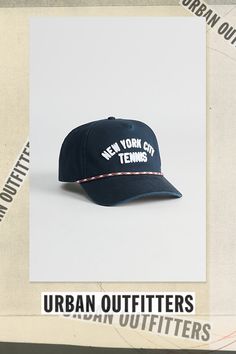 Rope trim cap by American Needle with text at the front. Adjustable fit hat with a snapback closure. Features American Needle NYC Tennis rope trim hat Paneled cotton cap Adjustable fit Snapback closure Content + Care Cotton Spot clean Imported Size Adjustable fit | American Needle NYC Tennis Rope Trim Hat in Navy, Men's at Urban Outfitters Cotton Snapback Hat With Sweatband, Navy Cotton 5-panel Baseball Cap, Sporty Cotton Dad Hat With Flat Bill, Sporty Cotton Baseball Cap With Flat Brim, Cotton 5-panel Snapback Hat For Sports, Retro Cotton Trucker Hat With Letter Print, Sporty Navy Hat With Flat Brim, Adjustable Snapback Hat With Cotton Sweatband, Navy Flat Brim Cotton Hat