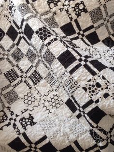 a black and white quilt is on display