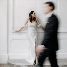 a woman in a white dress standing next to a man