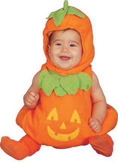 a baby dressed in an orange pumpkin costume