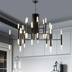 a modern chandelier hanging over a kitchen counter