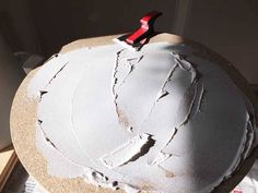 a cake with white frosting and red scissors on it