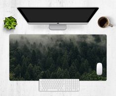 a computer mouse and keyboard sitting on top of a desk with trees in the background