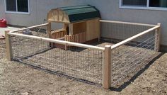 a chicken coop in front of a house