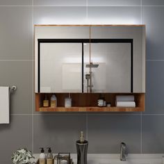 a bathroom with a sink, mirror and soap dispenser on the wall