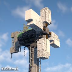 a very tall tower with lots of blocks on it's sides and plants growing out of the top