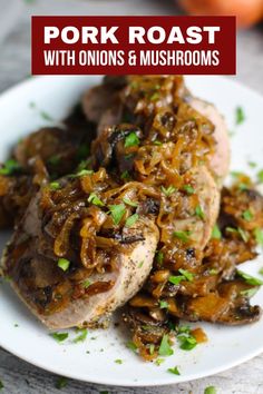 pork roast with onions and mushrooms served on a white plate, garnished with parsley