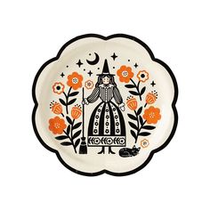 a white plate with an orange and black design on the front, surrounded by flowers