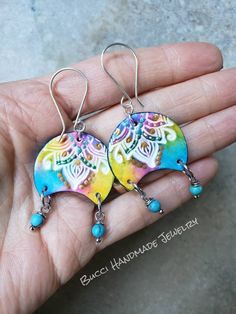 These brightly colored polymer clay earrings will bring joy to your world. Blue, yellow, pink, green and gold are handpainted onto these artisan beads for a boho, morrocan vibe. Two tiny blue magnesite beads dangle below. These are the lightweight and comfortable with sterling silver earwires. Multicolor Hand Painted Jewelry For Festivals, Bohemian Turquoise Hand Painted Jewelry, Turquoise Bohemian Hand Painted Jewelry, Bohemian Multicolor Hypoallergenic Jewelry, Green Bohemian Hand Painted Jewelry, Bohemian Colorful Earrings For Gift, Bohemian Multicolor Hypoallergenic Earrings, Pink Bohemian Hand Painted Jewelry, Green Bohemian Polymer Clay Jewelry