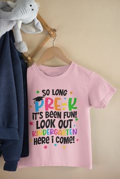 Welcome to my shop: MaryCrafterDesign! From Pre-K to Kindergarten - A Journey of Learning and Fun!?🎓🎉 Celebrate your child's transition from Pre-K to Kindergarten with this fun and colorful print! Perfect for your little one or as a gift for their teacher.   * High quality and super soft, comfortable shirt. Made with top-of-the-line DTF and pressed with a professional grade heat press. * Please check all color and size charts before place the order. Since all shirts are custom made based on yo Back To School Short Sleeve Shirt With Name Print, Crew Neck T-shirt With Name Print For Daycare, Pink T-shirt With Name Print For School, Pink Tops With Letter Print For School, Pink Short Sleeve T-shirt For School Events, Cotton Short Sleeve Tops For School Events, Back To School Name Print Tops For College, Name Print Tops For College Back To School, Crew Neck Tops For End Of School Year Events