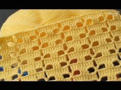 a yellow crocheted blanket sitting on top of a table