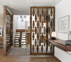 the interior of a house with wood and glass partitions on the wall, along with wooden flooring