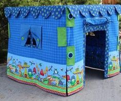 two children's play tents with blue and green fabric on the outside, one has a door