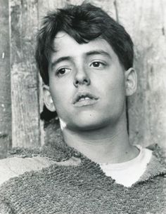 an old black and white photo of a young man in a sweater looking at the camera