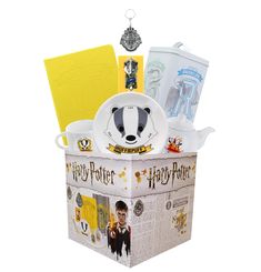 a harry potter birthday gift box with hogwarts dinnerware and other items in it