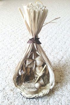 a bag filled with seashells on top of a white carpet