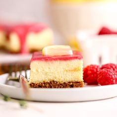 a piece of cheesecake with raspberries on a plate