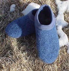 a pair of blue slippers sitting on top of dry grass