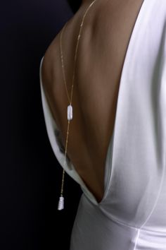 This simple and dainty back drop necklace features two freshwater biwa pearls and looks great with backless tops and dresses. There is no clasp, it is completely reversible, so you can wear it in the front over a sweater or tee. So lightweight - you won't even know it's on! "BIWA FRESHWATER PEARL BACK DROP NECKLACE" by GoldenLinings - Christine Elizabeth Jewelry D E T A I L S Materials: 14K Gold Fill or Sterling Silver S I Z E S Measures 26" (so you can put it over your head) Drop measures: approx 4" M A T E R I A L S With so many terms to describe gold jewelry, it can be confusing to know exactly what you're buying and how to care for it. Gold fill contains 100+ times more real gold than gold-plated jewelry. It is heat bonded, making it more durable than gold-plated jewelry. It's a great Christine Elizabeth Jewelry, Minimalist Lariat Backdrop Necklace With Pearl Pendant, Elegant Long Drop Backdrop Necklace For Party, Delicate White Backdrop Necklace For Formal Occasions, Delicate Lariat Necklace For Party, Minimalist Pearl Drop Lariat Backdrop Necklace, Minimalist Pearl Pendant Drop Necklace For Formal Occasions, Minimalist Lariat Backdrop Necklace With Pearl Drop, Minimalist Pearl Pendant Backdrop Necklace As Gift