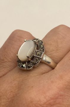 Vintage hand made mother of pearl set in 925 sterling silver ring I have size 8 Can be re sized for you, my jeweler charges a $10-$20 fee All rings are shipped free in the US in a nice gift box. Check out our over a THOUSAND great reviews Engraving is $4 per letter and is not always perfect depending on the piece. It can take a few days if the jeweler is busy. This is payable to Paypal Judithsltd@gmail.com White Hallmarked Opal Ring Fine Jewelry, Elegant Collectible Moonstone Ring, Antique White Oval Moonstone Ring, White Oval Stone Setting Jewelry, White Oval Stone Set Jewelry, Gift White Opal Gemstone Ring, Antique White Pearl Ring Hallmarked, White Cabochon Moonstone Ring In Fine Jewelry Style, Classic White Opal Ring For Gift