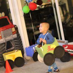 a little boy that is standing in front of some toys