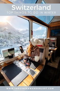 a woman sitting at a table with a glass of wine in front of her and the words switzerland top things to do in winter