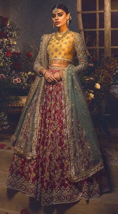 a woman in a red and gold lehenga