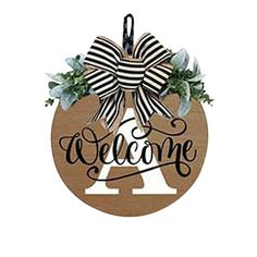 a wooden sign that says welcome with a bow