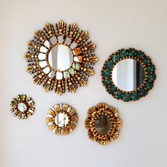 three mirrors, one is gold and the other is green