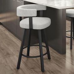 a white counter top sitting next to two stools