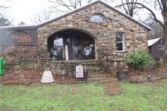 an old stone building with a clock on the front