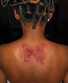 a woman with a butterfly tattoo on her back