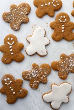 gingerbread cookies with icing and sprinkles arranged on a white surface