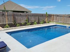 an empty swimming pool in the middle of a backyard