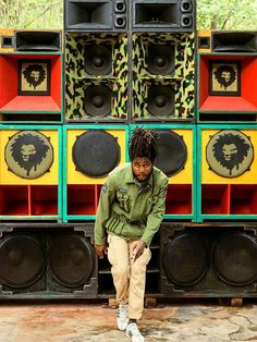 a man sitting in front of some speakers