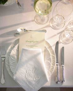 a table set with silverware and napkins