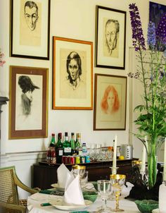 a dining room with pictures on the wall