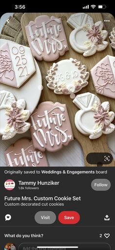 some cookies that are on top of a wooden table and one is decorated with icing