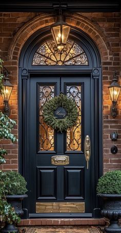 a black front door with a wreath on it