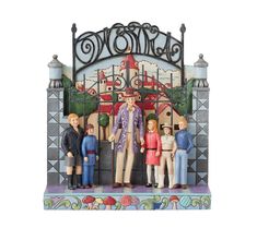 a group of figurines standing in front of a gate