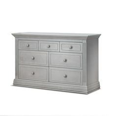 a white dresser with four drawers and two doors