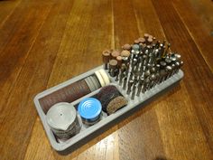 a wooden table topped with lots of different types of screwdrivers and other items