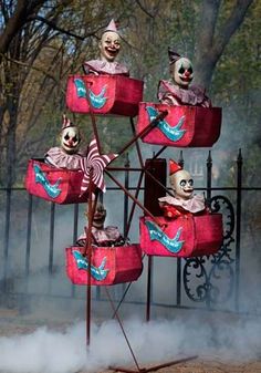 there are many clowns on top of the carnival rides in the smokey area